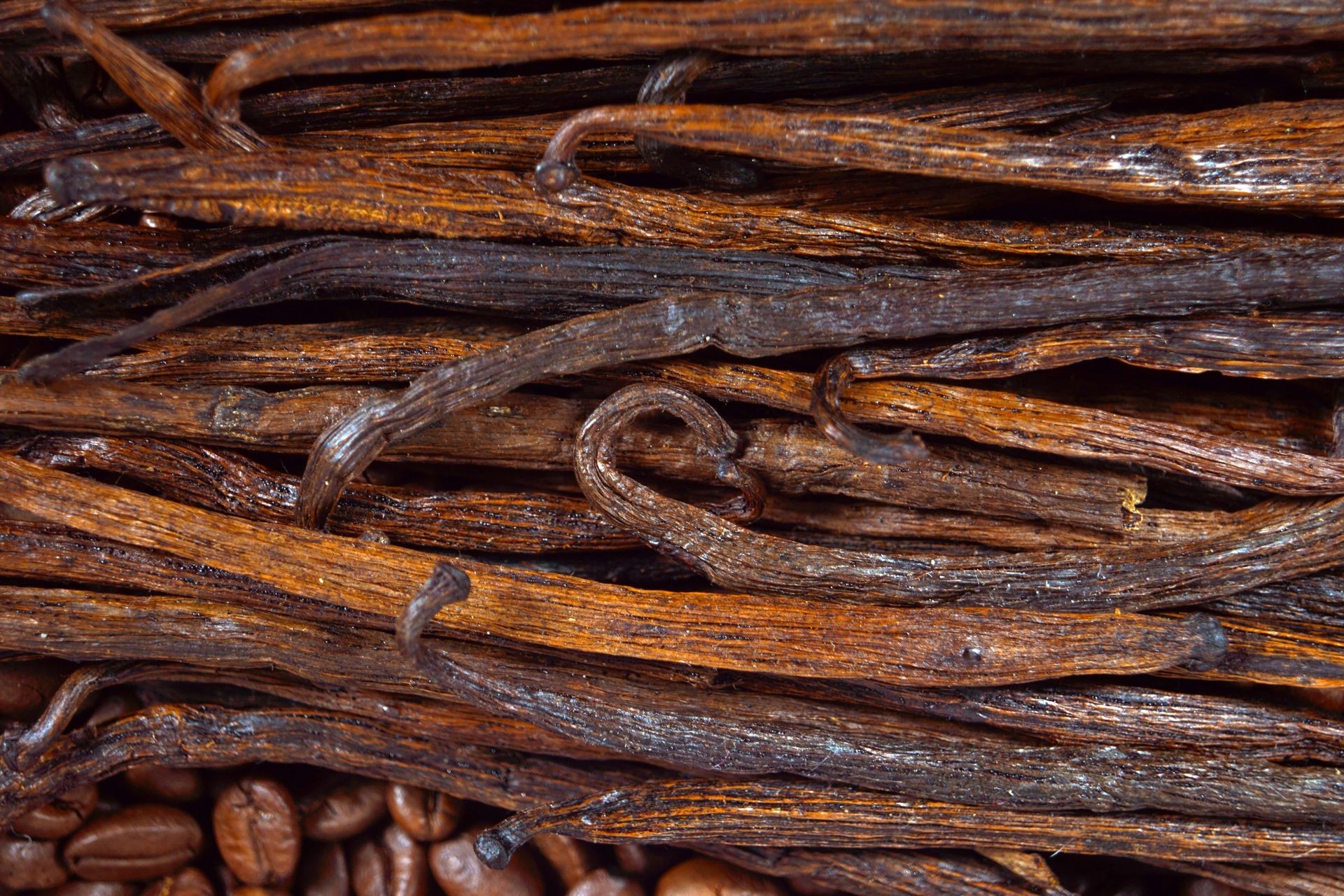 Close-up of dried vanilla beans stacked together.